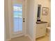 Powder room featuring a door to the outside and pedestal sink at 2679 Saddlewood Ln, Palm Harbor, FL 34685