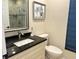 Bathroom featuring granite countertop, white cabinetry, framed mirror and neutral paint at 2679 Saddlewood Ln, Palm Harbor, FL 34685