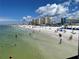 Beautiful beach with white sand, blue water, and multiple high rise hotels at 2679 Saddlewood Ln, Palm Harbor, FL 34685