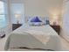 Relaxing bedroom with plantation shutters, comfortable bed and neutral color palette at 2679 Saddlewood Ln, Palm Harbor, FL 34685