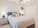 Well-lit bedroom with a ceiling fan, wreath, and comfortable furnishings at 2679 Saddlewood Ln, Palm Harbor, FL 34685
