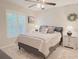 Bright bedroom featuring a ceiling fan, neutral walls, and stylish decor at 2679 Saddlewood Ln, Palm Harbor, FL 34685