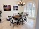 Elegant dining room featuring a dark wood table, upholstered chairs, and a large arched window at 2679 Saddlewood Ln, Palm Harbor, FL 34685