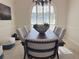 Dining room area with elegant table set and chair set, arch window, and light at 2679 Saddlewood Ln, Palm Harbor, FL 34685