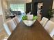 Dining area showcasing a dark wood table with decorative centerpiece, flowing into the living room at 2679 Saddlewood Ln, Palm Harbor, FL 34685