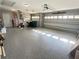 Spacious garage with epoxy flooring, multiple bays, and storage options at 2679 Saddlewood Ln, Palm Harbor, FL 34685