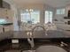 Kitchen sink view showcasing the open floor plan with a view of the living and dining areas at 2679 Saddlewood Ln, Palm Harbor, FL 34685