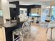 Open-concept kitchen featuring granite countertops, a breakfast bar, and an adjacent dining area at 2679 Saddlewood Ln, Palm Harbor, FL 34685