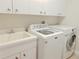 Bright laundry room with modern appliances, ample counter space, and storage at 2679 Saddlewood Ln, Palm Harbor, FL 34685
