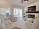 Bright living room featuring a fireplace, comfortable seating, and access to a screened lanai at 2679 Saddlewood Ln, Palm Harbor, FL 34685