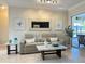 Inviting living room with a comfortable sofa, modern decor, and access to the screened patio at 2679 Saddlewood Ln, Palm Harbor, FL 34685
