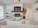 Cozy living room with a stone fireplace, neutral furniture, and access to the outdoor space at 2679 Saddlewood Ln, Palm Harbor, FL 34685