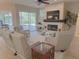 Bright living room featuring neutral tones, fireplace, ceiling fan, and sliding glass doors to the lanai and pool at 2679 Saddlewood Ln, Palm Harbor, FL 34685
