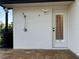 Outdoor shower and entry door on patio with view into the home at 2679 Saddlewood Ln, Palm Harbor, FL 34685