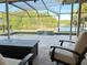 Relaxing poolside view of the lake, with comfortable seating and a soothing waterfall feature at 2679 Saddlewood Ln, Palm Harbor, FL 34685
