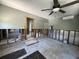 Basement area under renovation with visible framing, concrete floors, and ceiling fan at 3008 Dupont S St, Gulfport, FL 33707