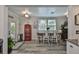 Bright dining area featuring a farmhouse table, modern decor, and stylish flooring, adjacent to the kitchen at 3008 Dupont S St, Gulfport, FL 33707