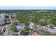 Sweeping aerial shot demonstrating the home's location near local businesses and lush surroundings at 3027 Burlington N Ave, St Petersburg, FL 33713