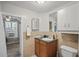 Another view of the functional bathroom featuring single sink, toilet, tiled walls, and storage at 3027 Burlington N Ave, St Petersburg, FL 33713