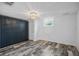 Bedroom featuring a closet, a decorative light fixture and stylish wood-look flooring at 3027 Burlington N Ave, St Petersburg, FL 33713