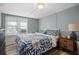 Bedroom with blue patterned bedding, light blue walls, and wood-look flooring at 3027 Burlington N Ave, St Petersburg, FL 33713