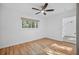 Cozy bedroom with hardwood floors, a ceiling fan and a window letting in natural light at 3027 Burlington N Ave, St Petersburg, FL 33713