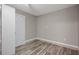 Simple bedroom with wood-look vinyl flooring, closet, and light-colored walls, offering a clean and neutral space at 3027 Burlington N Ave, St Petersburg, FL 33713