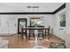 Bright dining area showcasing a modern chandelier and a view to the front yard at 3027 Burlington N Ave, St Petersburg, FL 33713