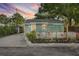 Cozy home with a charming, fenced-in front porch, complimented by lovely landscaping and outdoor lighting at 3027 Burlington N Ave, St Petersburg, FL 33713