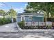 Charming blue home with well-maintained landscaping, white rock, a small porch, and a cozy front yard at 3027 Burlington N Ave, St Petersburg, FL 33713