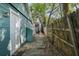 Side exterior view of the house, showing a narrow walkway and a partial fence at 3027 Burlington N Ave, St Petersburg, FL 33713