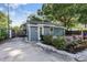 Quaint blue home with landscaped garden, white rock, and a cozy front porch, and driveway at 3027 Burlington N Ave, St Petersburg, FL 33713