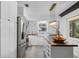 Bright kitchen with marble backsplash, wood countertops, stainless steel appliances, and modern pendant lighting at 3027 Burlington N Ave, St Petersburg, FL 33713