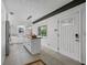 Modern kitchen with sleek white cabinetry, wood countertops, and stainless-steel appliances at 3027 Burlington N Ave, St Petersburg, FL 33713