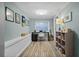 Home office area with wood-look flooring, desk, and built-in shelving for storage at 3027 Burlington N Ave, St Petersburg, FL 33713