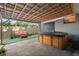 Outdoor patio featuring a hot tub beneath a covered area with wood beams and a metal roof at 3027 Burlington N Ave, St Petersburg, FL 33713