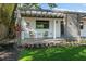 Inviting porch features a covered seating area, modern chairs, and freshly landscaped flower beds at 3027 Burlington N Ave, St Petersburg, FL 33713