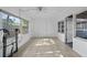 Enclosed sun room with tile flooring, bright lighting, and windows at 3027 Burlington N Ave, St Petersburg, FL 33713