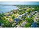 Aerial view showcases a waterfront neighborhood with lush landscapes, serene waterways, and charming homes at 321 Shore E Dr, Oldsmar, FL 34677