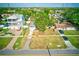 Overhead view of a home with manicured lawn, mature trees, and proximity to neighboring houses and the street at 321 Shore E Dr, Oldsmar, FL 34677
