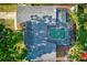 An aerial shot features a home with a private screened-in pool and lush surrounding greenery at 321 Shore E Dr, Oldsmar, FL 34677