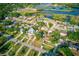 Aerial view showcasing a residential neighborhood with lush landscaping and a scenic waterfront area at 321 Shore E Dr, Oldsmar, FL 34677