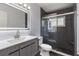 Modern bathroom featuring a sleek vanity, a large mirror, and a glass-enclosed shower with dark tile surround at 321 Shore E Dr, Oldsmar, FL 34677