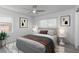 Staged bedroom showcasing modern decor, new flooring, ceiling fan and ample natural light at 321 Shore E Dr, Oldsmar, FL 34677