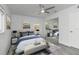 Light and bright bedroom with a ceiling fan, neutral paint, and a mirrored closet that enhances spaciousness at 321 Shore E Dr, Oldsmar, FL 34677