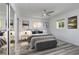 Staged bedroom showcasing modern decor, new flooring, ceiling fan and ample natural light at 321 Shore E Dr, Oldsmar, FL 34677
