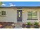 Inviting front entrance with a stylish door, well-maintained landscaping, and charming exterior details at 321 Shore E Dr, Oldsmar, FL 34677