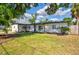 Charming single-story home boasts a beautifully landscaped front yard and freshly painted exterior at 321 Shore E Dr, Oldsmar, FL 34677