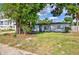 Well-maintained home with lush front lawn and mature trees at 321 Shore E Dr, Oldsmar, FL 34677