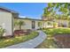 Charming single-story home featuring a well-maintained front yard with lush landscaping and a curved walkway at 321 Shore E Dr, Oldsmar, FL 34677